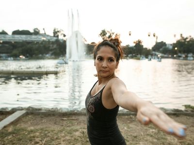 Shadow of a person doing a stretching pose on wall.